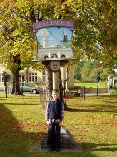 Small Thomas in 2004 with the Spaldwick village sign